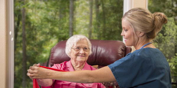 Senior adult patient with home healthcare nurse. Physical therapy.