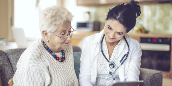 Care worker is visiting a senior woman