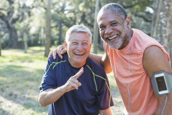 two elderly men resting after a run outdoors