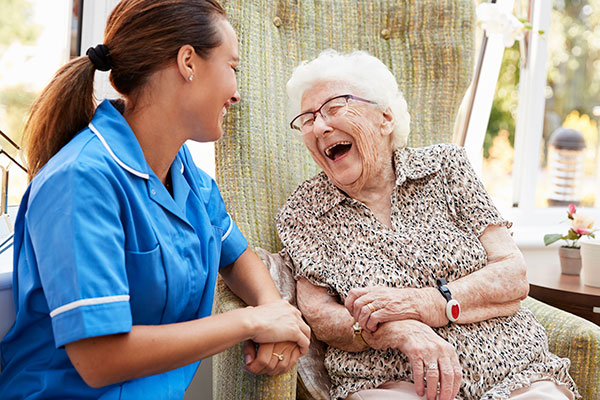senior woman laughing with caregiver
