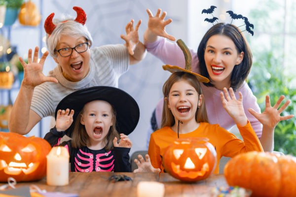 Happy family celebrating Halloween. Grandmother, mother and children at home.